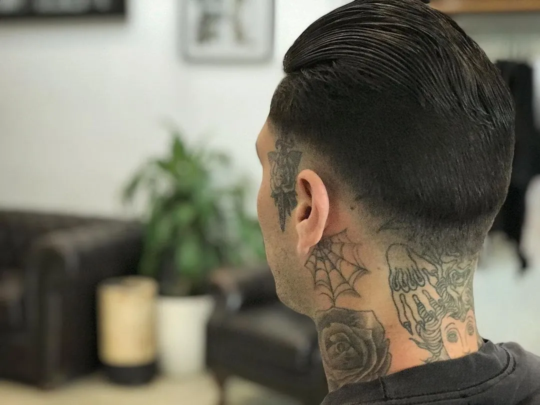 Freshly cut slicked-back hairstyle with a sharp faded neckline