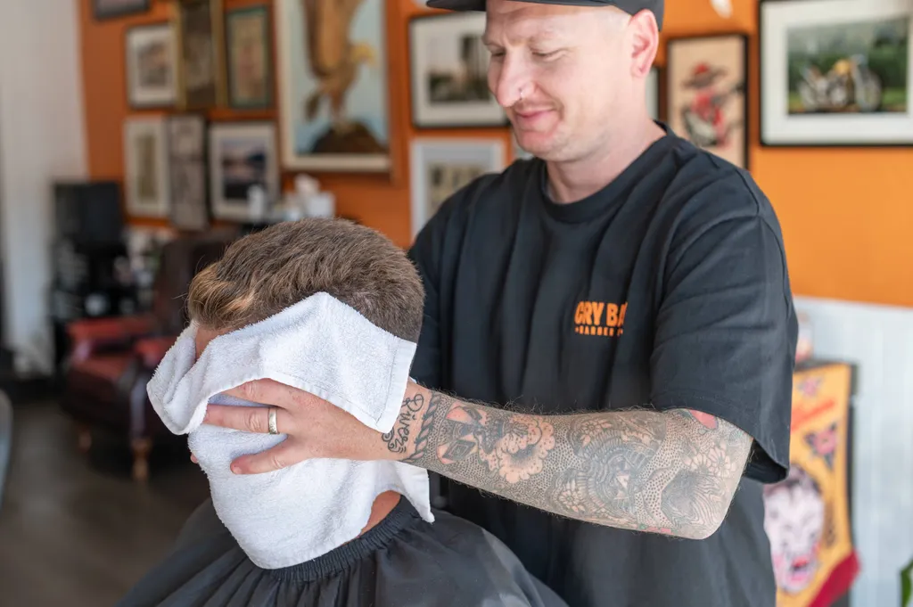 Client relaxing under a hot towel after a haircut